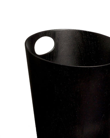 Cropped image focused on handle of black ash paper waste basket by Isamu Saito against white background.