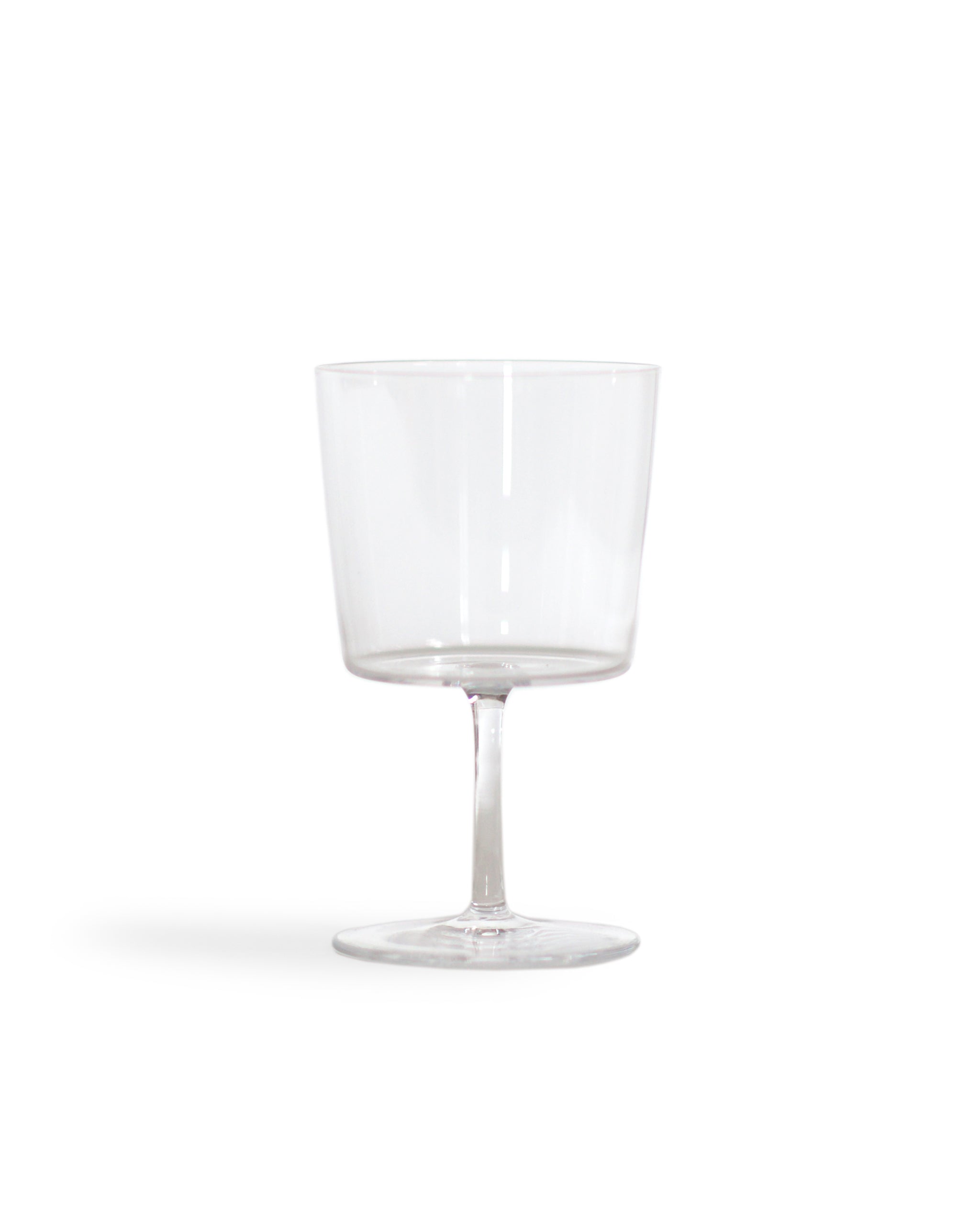 Silhouetted time and style raisin glass against white background.
