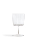 Silhouetted time and style raisin glass against white background.