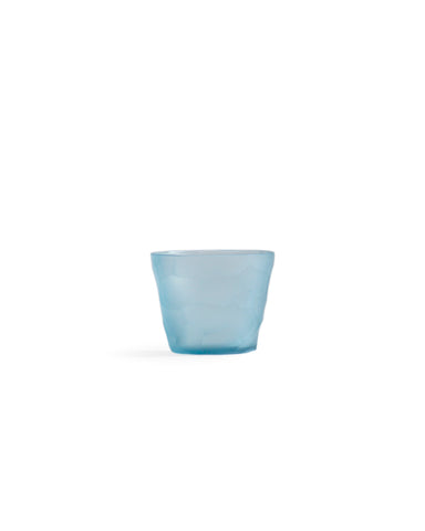 Silhouetted light blue reclaimed blue mini choko glass in rock pattern, against white background.