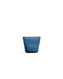 Silhouetted dark blue reclaimed blue mini choko glass in rock pattern, against white background.