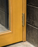 Matureware Brass Flat Hinge Small installed on closed wooden door