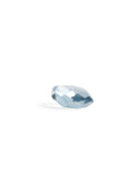 Silhouetted light blue reclaimed blue jewelry cut paperweight against white background. 